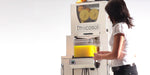 Person approaching the Frucosol juice machine to extract juice from the unit.