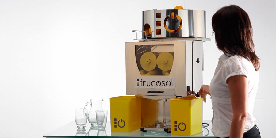 Person interacting with the Frucosol F50A Juicer on a white background