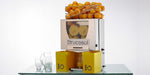 Frucosol F50 Juicer filling up a glass of juice in a front facing view.