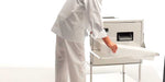 Frucosol SH7000 Cutlery Polisher, a person removing the cutlery tray from the unit.