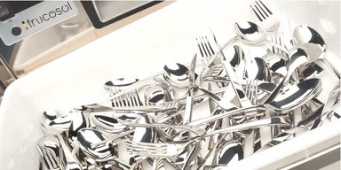 Set of silver cutlery including forks, knives, and spoons in the white cutlery tray with 'frucosol' branding behind.