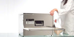 Frucosol SH3000 Cutlery Polisher, person taking the lid off of the unit to add cutlery polishing grain to the appliance.